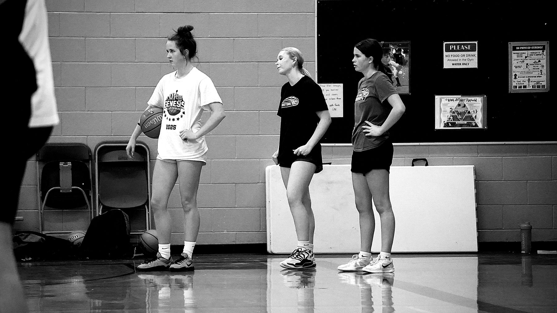 Three girls waiting their turn during a drill